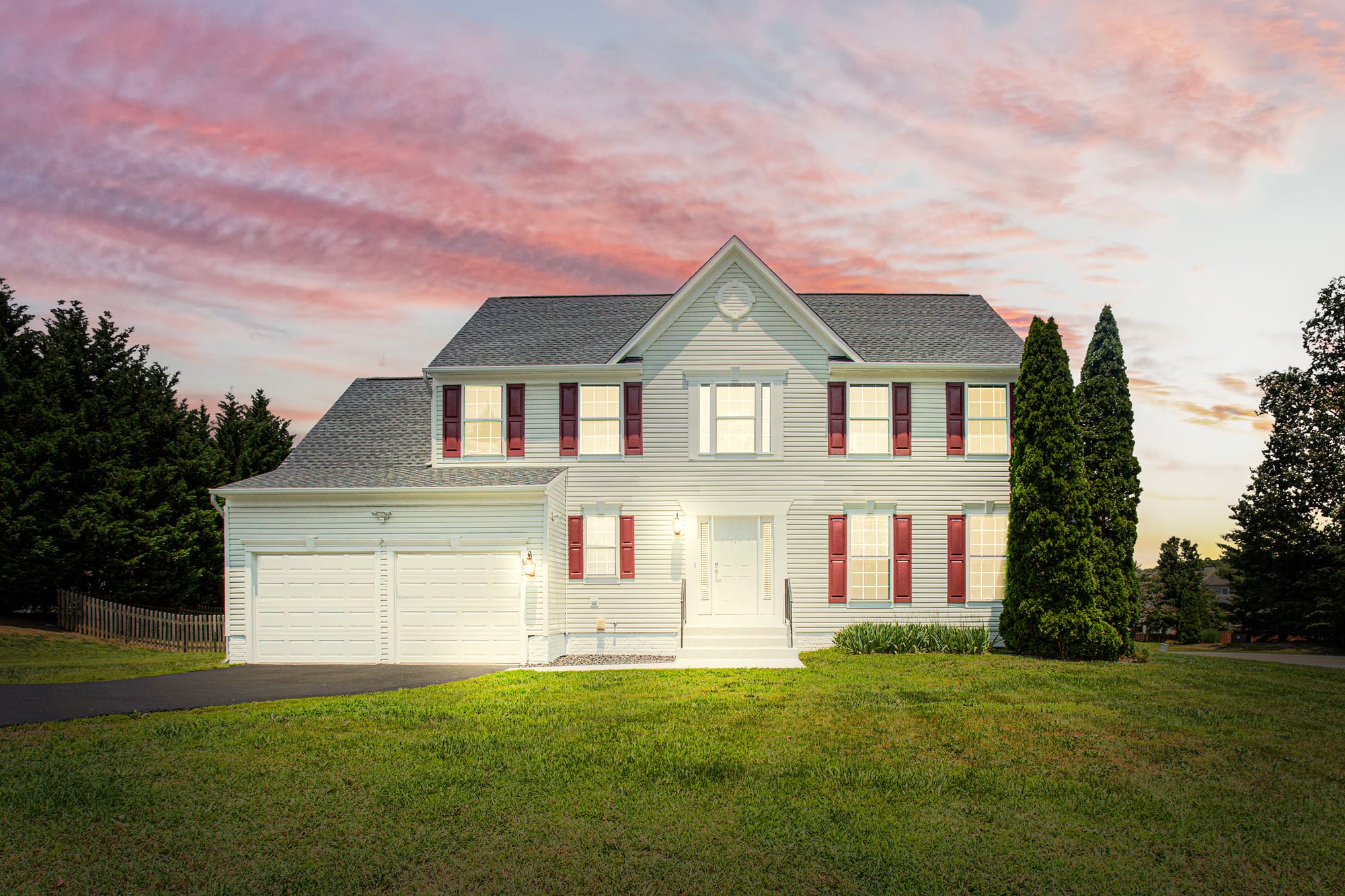 Front exterior of 4001 Mossy Bank Lane at dusk under a pink sky